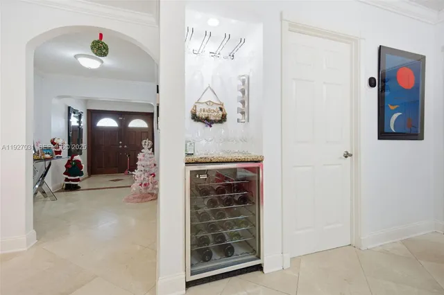 a view of a hallway with entryway and dining room view