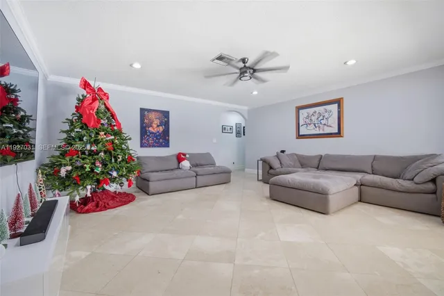 a living room with furniture and flowers