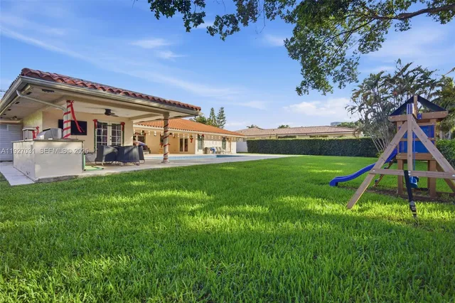 a view of a house with a big yard and potted plants