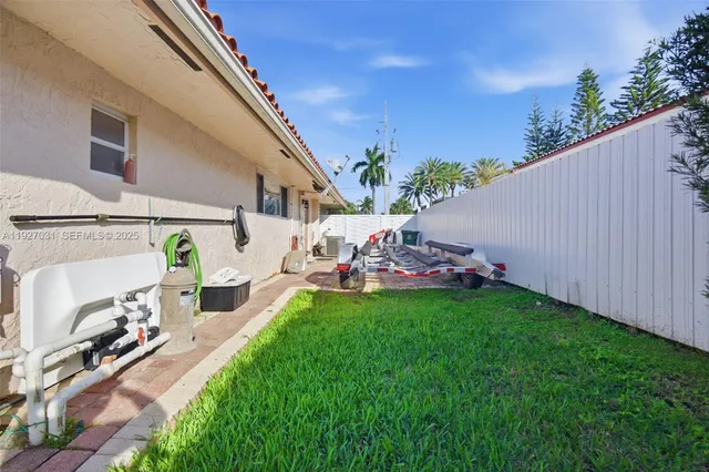 a view of a backyard with plants and a patio