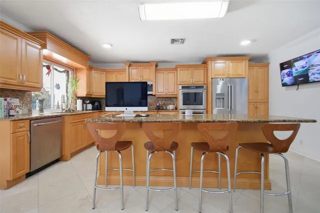 a dining table with chairs and view kitchen