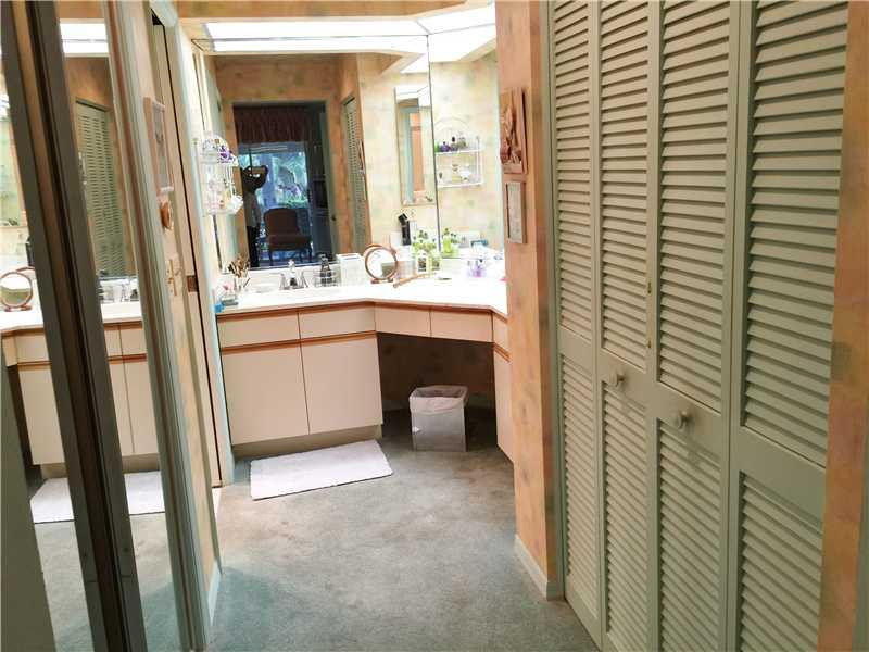 11096 Rios Road, Unit 11096 Boca Raton, FL 33498 - Photo 11 of 35 a bathroom with a sink and a mirror