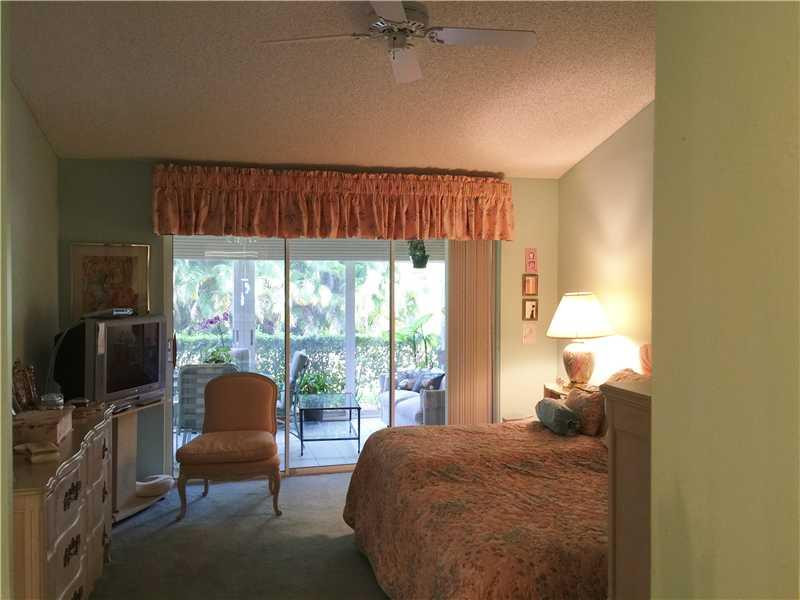 11096 Rios Road, Unit 11096 Boca Raton, FL 33498 - Photo 9 of 35 a bedroom with a bed and a chair