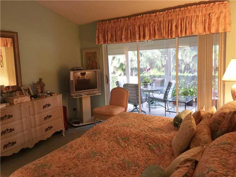 11096 Rios Road, Unit 11096 Boca Raton, FL 33498 - Photo 10 of 35 a bedroom with a bed and large windows