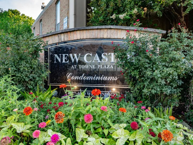 a sign that is in front of flowers