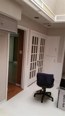 a view of a workspace with furniture and a window