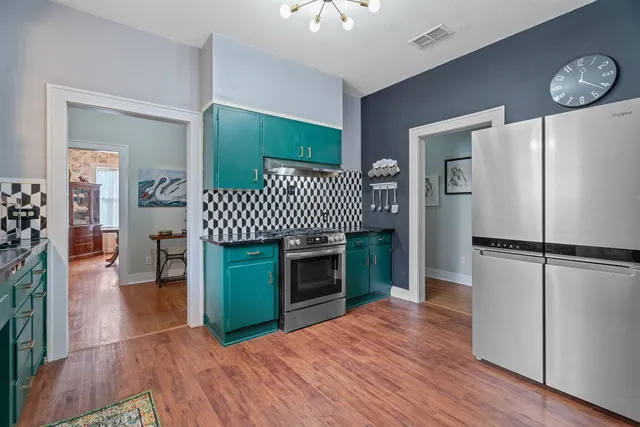 a kitchen with a refrigerator and a kitchen view