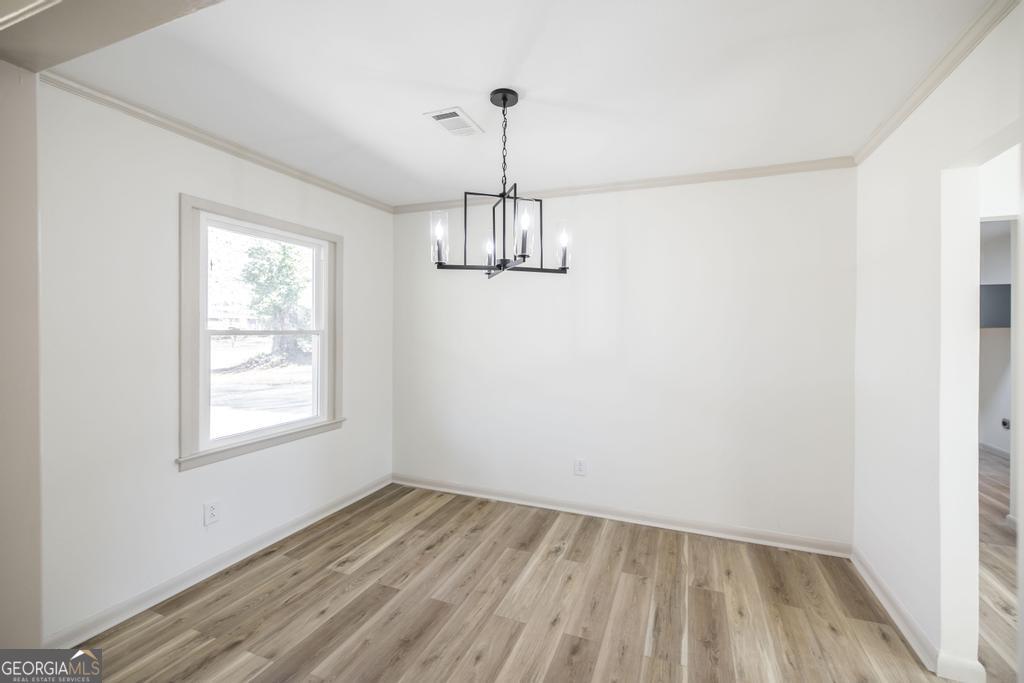 103 Spring Street Warner Robins, GA 31088 - Photo 11 of 30 wooden floor in an empty room with a window