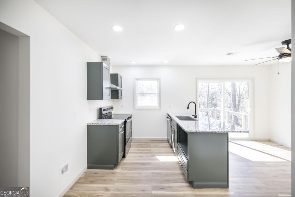 103 Spring Street Warner Robins, GA 31088 - Photo 12 of 30 a kitchen with stainless steel appliances granite countertop a sink and dishwasher a stove with wooden floor