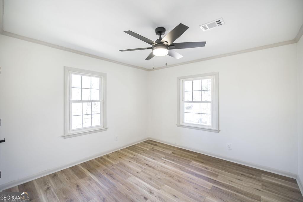 103 Spring Street Warner Robins, GA 31088 - Photo 18 of 30 wooden floor in an empty room with a window