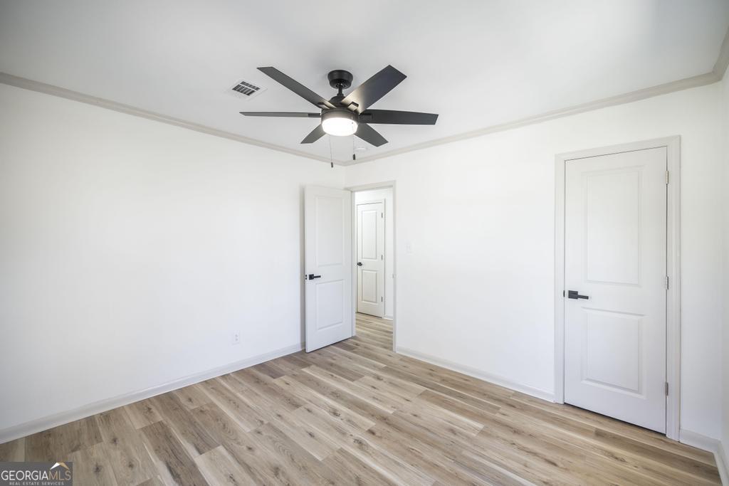 103 Spring Street Warner Robins, GA 31088 - Photo 19 of 30 a view of a big room with wooden floor and closet in a room