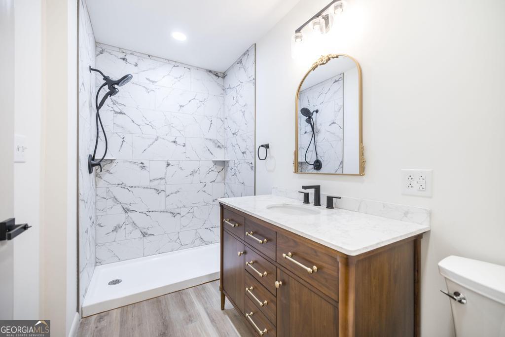 103 Spring Street Warner Robins, GA 31088 - Photo 23 of 30 a bathroom with a sink vanity mirror and shower