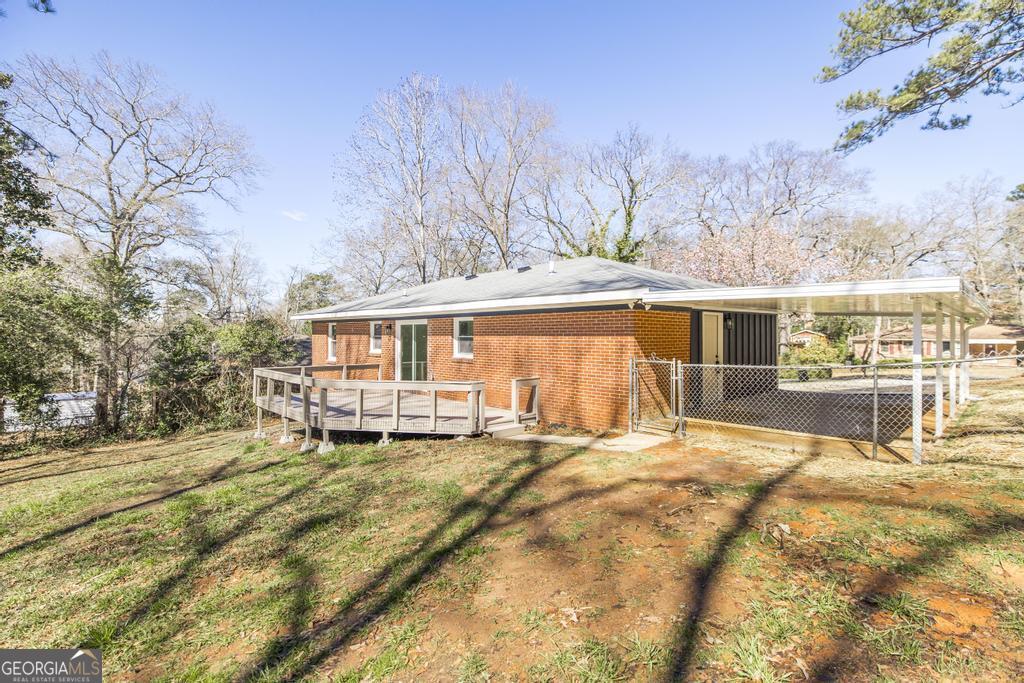 103 Spring Street Warner Robins, GA 31088 - Photo 27 of 30 a front view of a house with a yard patio and dinning table