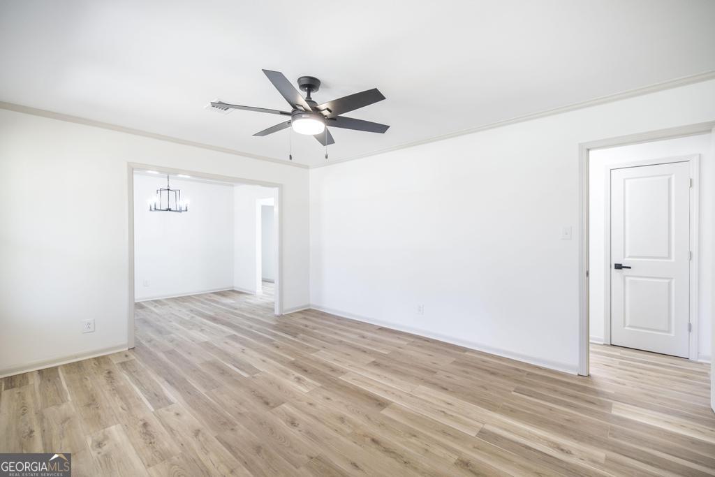 103 Spring Street Warner Robins, GA 31088 - Photo 8 of 30 a view of empty room with wooden floor and ceiling fan