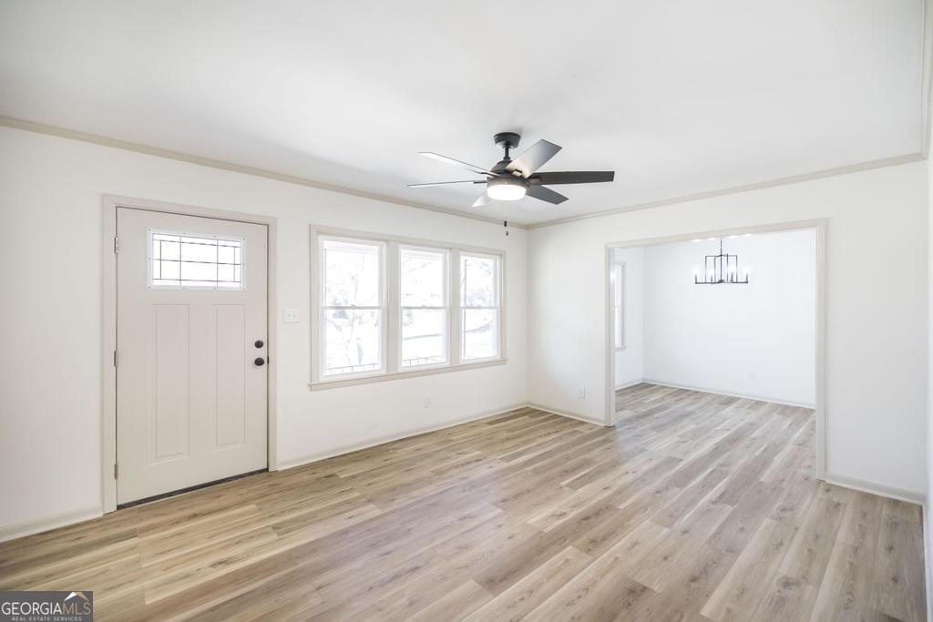103 Spring Street Warner Robins, GA 31088 - Photo 9 of 30 an empty room with wooden floor and windows