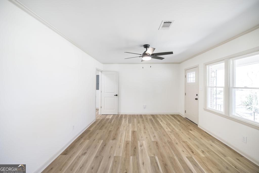103 Spring Street Warner Robins, GA 31088 - Photo 10 of 30 wooden floor in an empty room with a window