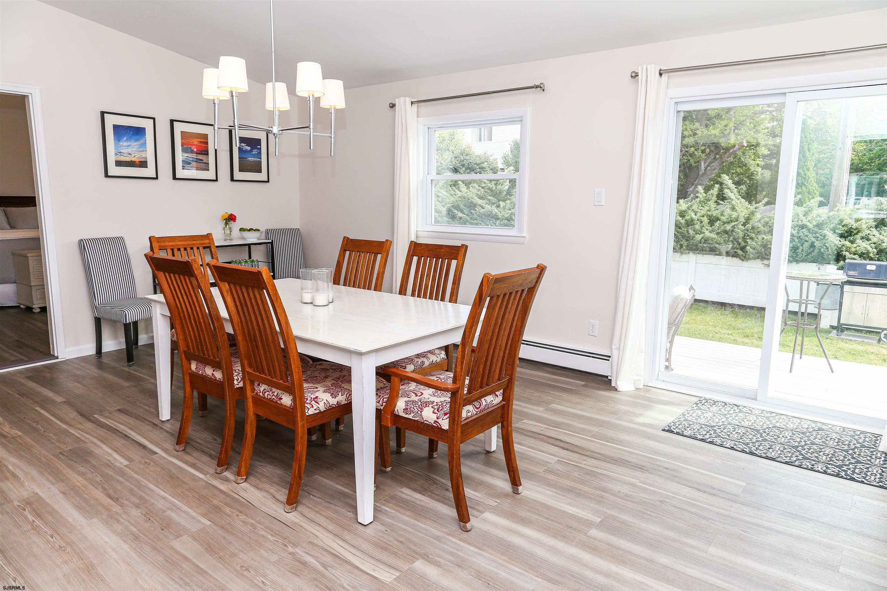 307 28th Street South Brigantine, NJ 08203 - Photo 14 of 38 a view of a dining room with furniture a chandelier and wooden floor