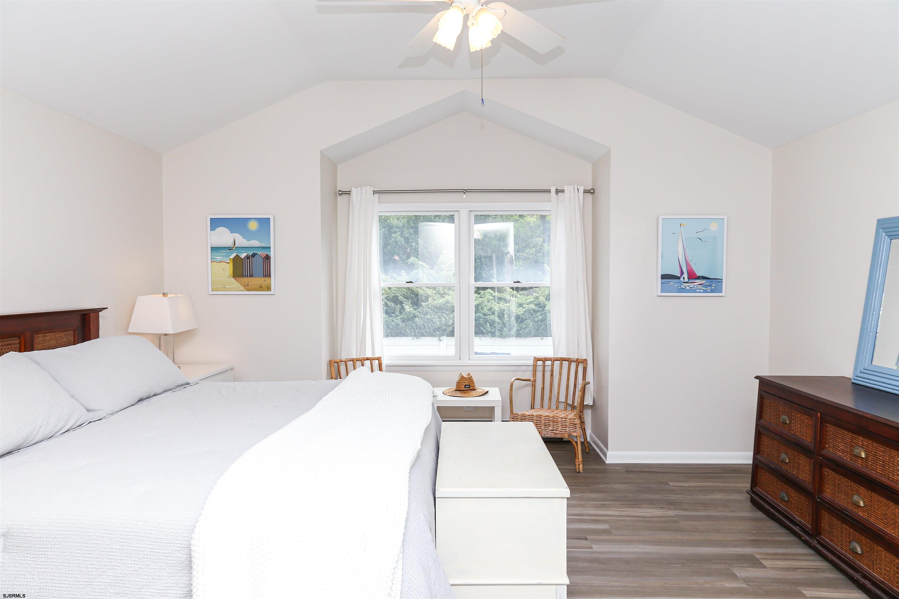 307 28th Street South Brigantine, NJ 08203 - Photo 17 of 38 a bed room with a bed a couch and a chandelier