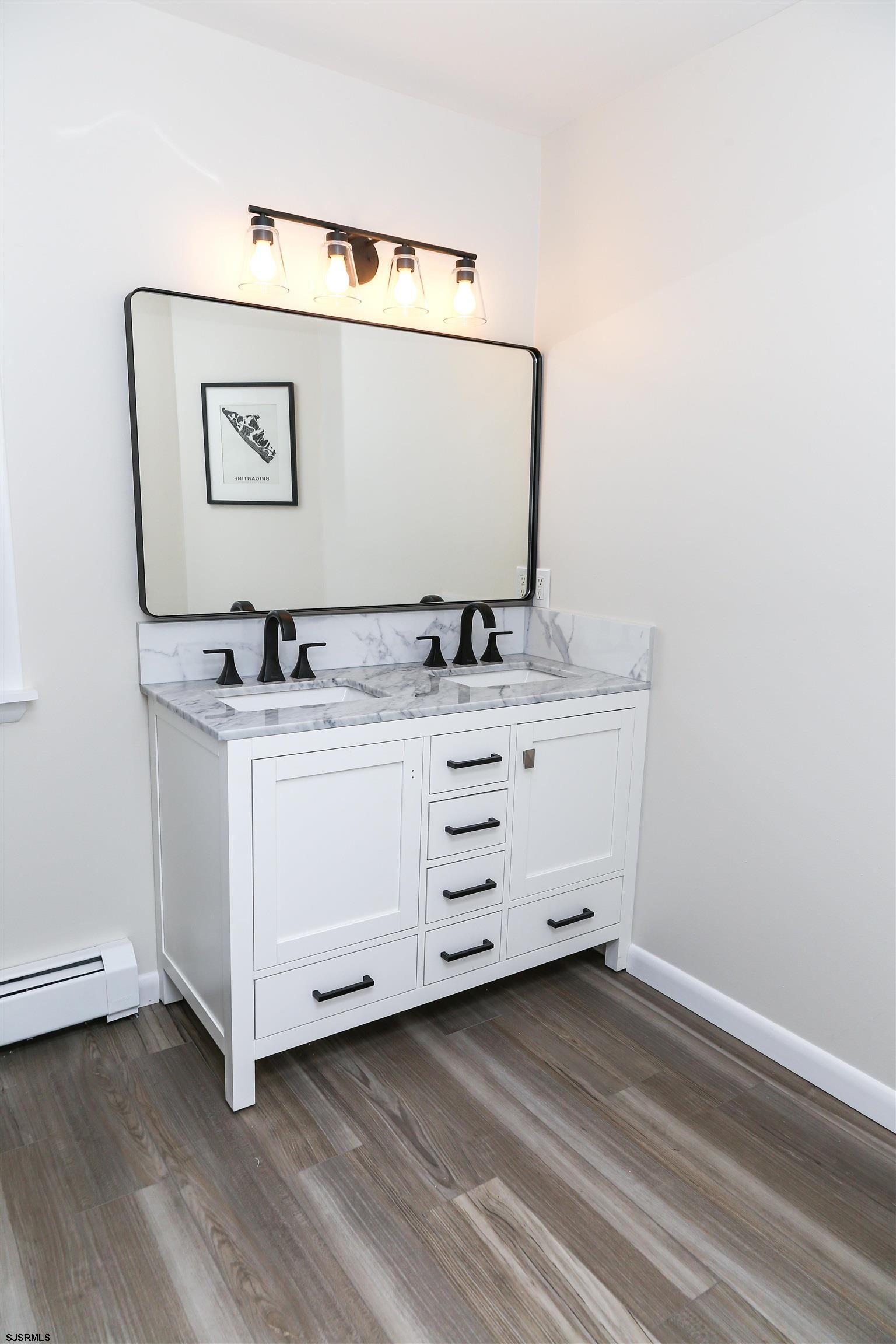 307 28th Street South Brigantine, NJ 08203 - Photo 19 of 38 a bathroom with a sink and mirror