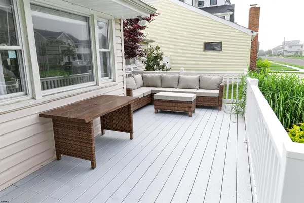 a balcony with furniture and wooden floor