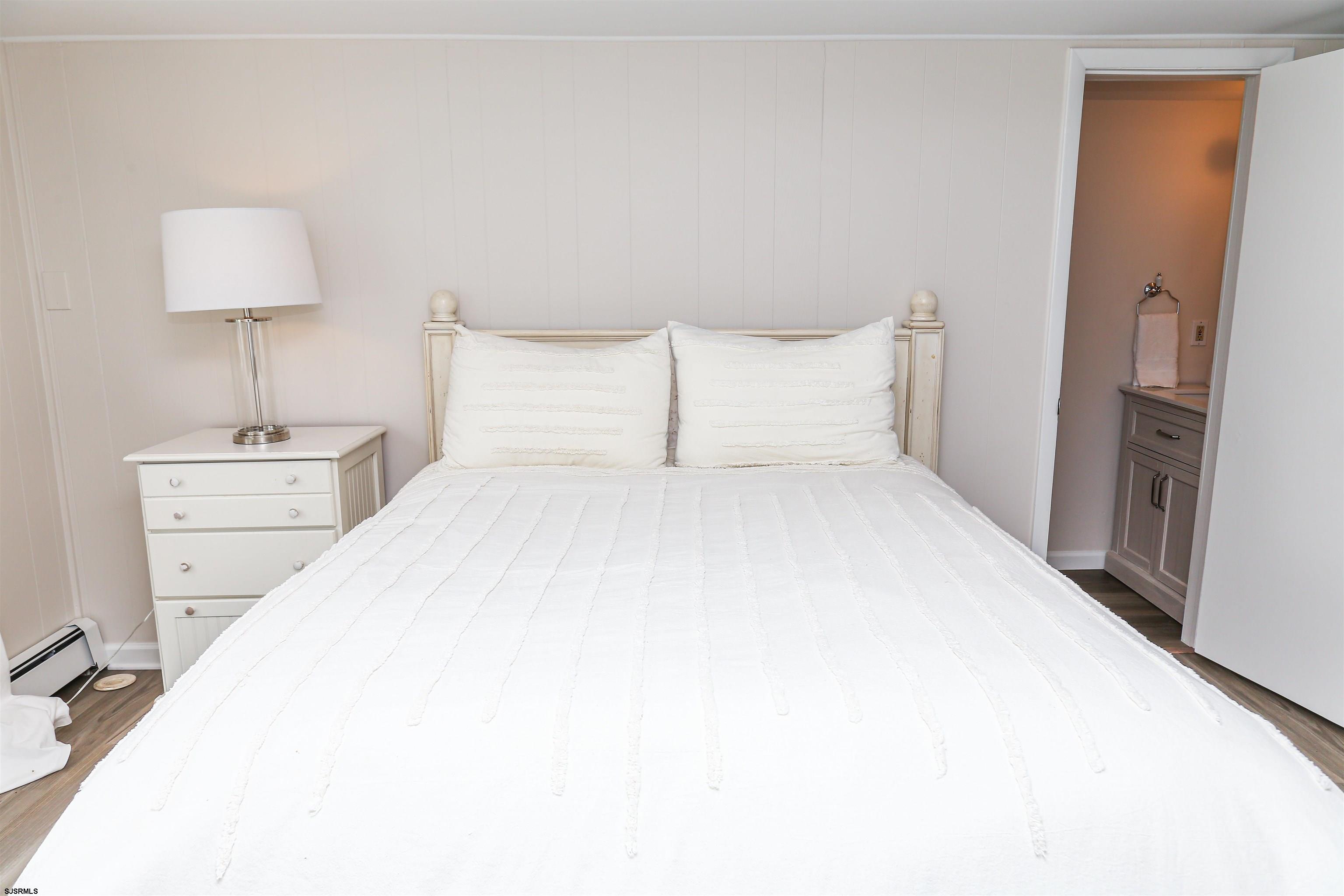307 28th Street South Brigantine, NJ 08203 - Photo 22 of 38 a large bed sitting in a bedroom and a lamp