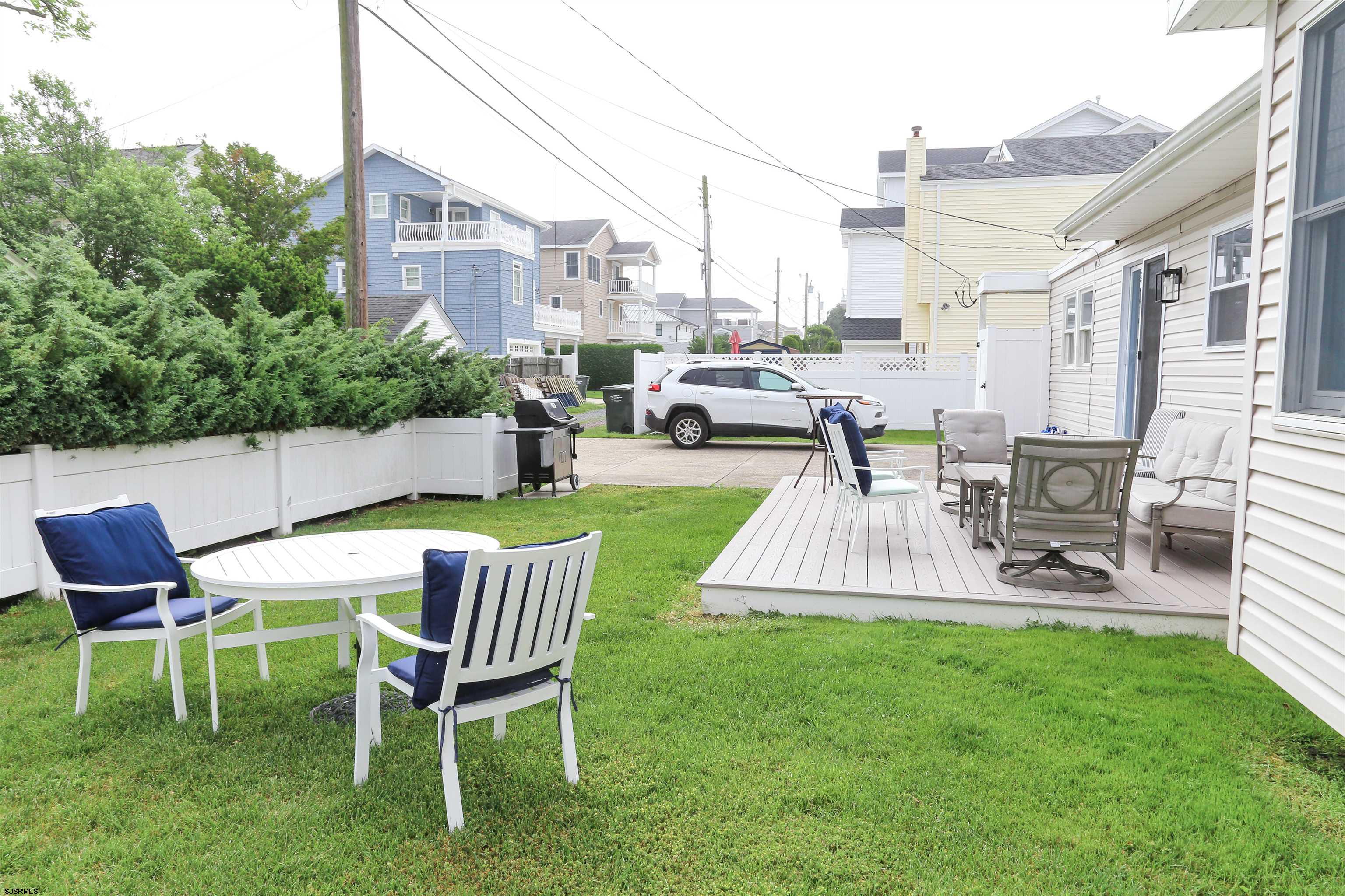 307 28th Street South Brigantine, NJ 08203 - Photo 36 of 38 a view of backyard of house with outdoor seating and green space