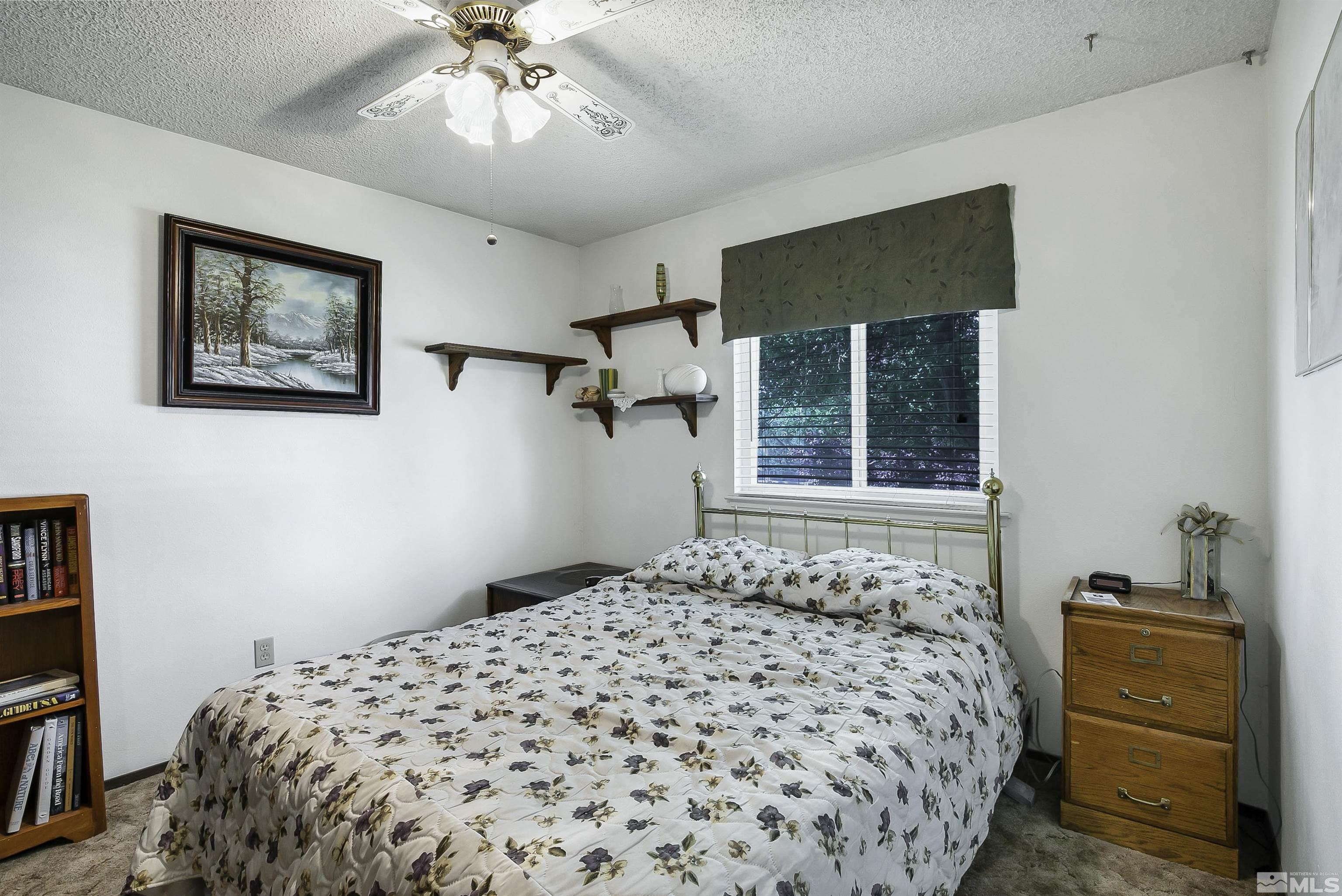 14075 Tourmaline Drive Reno, NV 89521 - Photo 17 of 37 a bedroom with a bed and a window