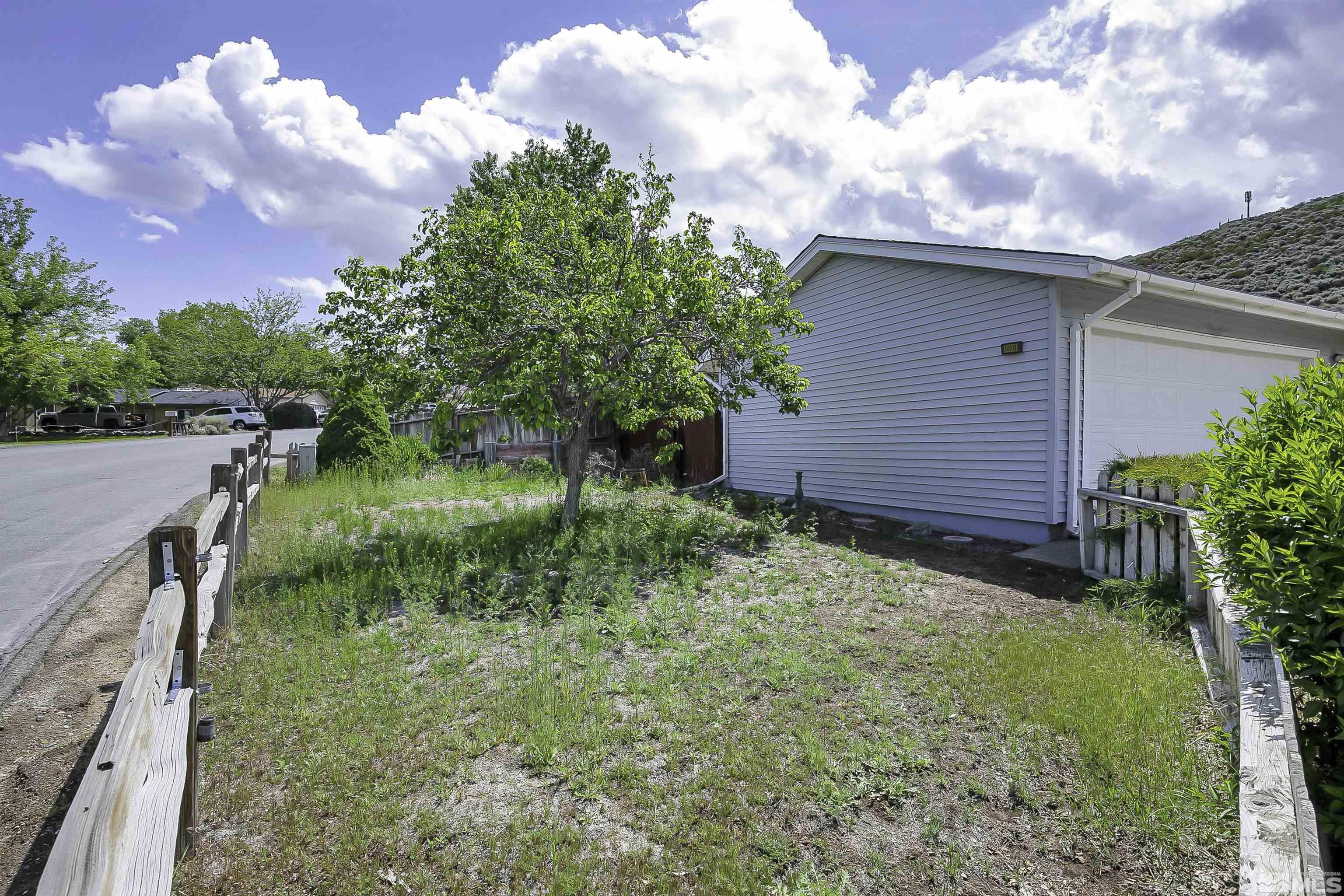 14075 Tourmaline Drive Reno, NV 89521 - Photo 32 of 37 a backyard of a house with lots of green space
