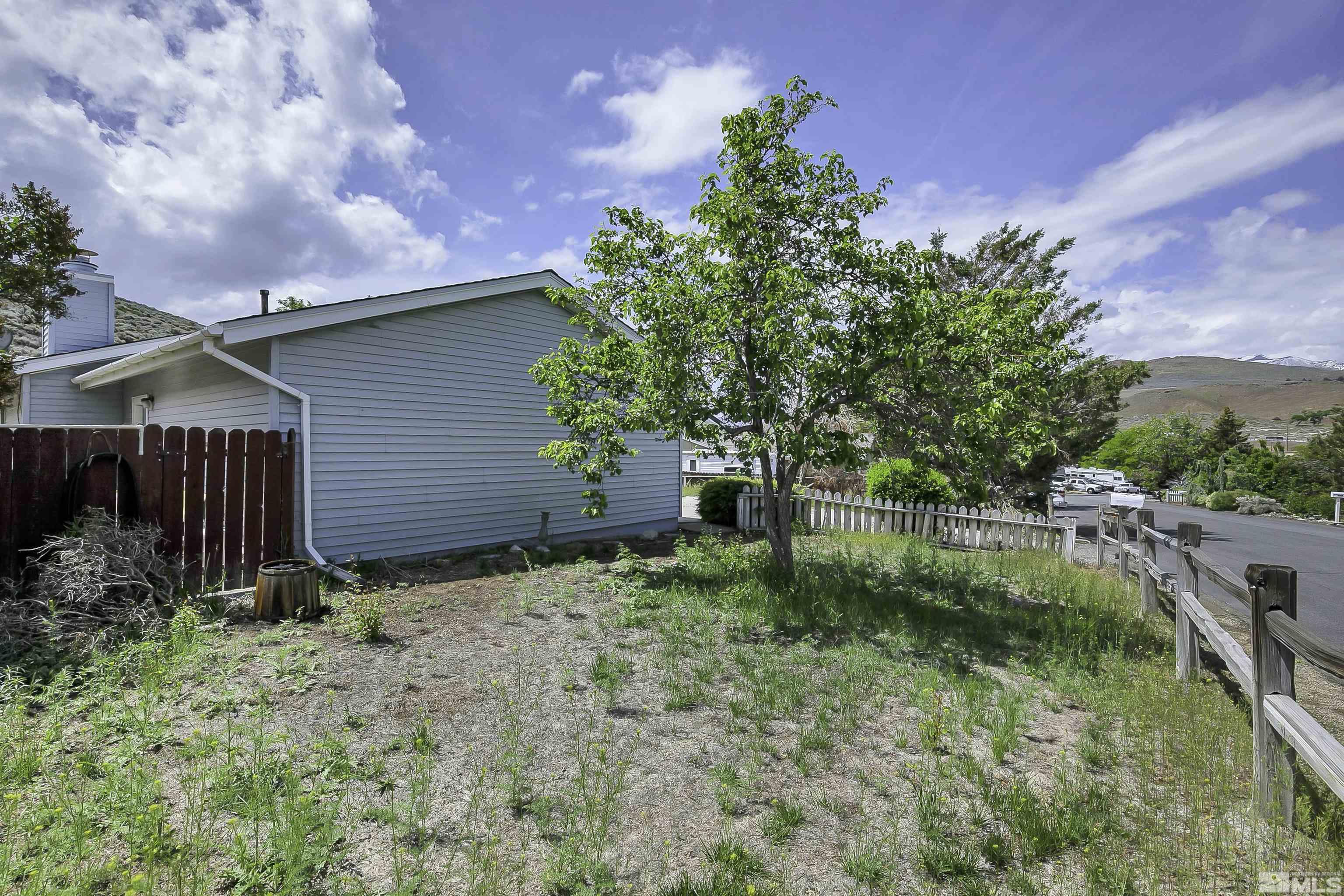 14075 Tourmaline Drive Reno, NV 89521 - Photo 34 of 37 a backyard of a house with lots of green space