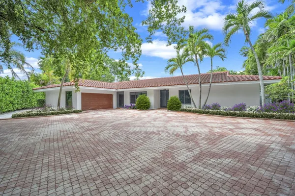 a front view of a house with a yard and a garage