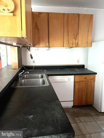 a kitchen with a refrigerator a stove and a microwave