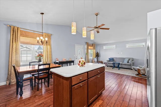 a room with a table chairs and wooden floor