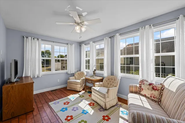 a living room with furniture and large windows