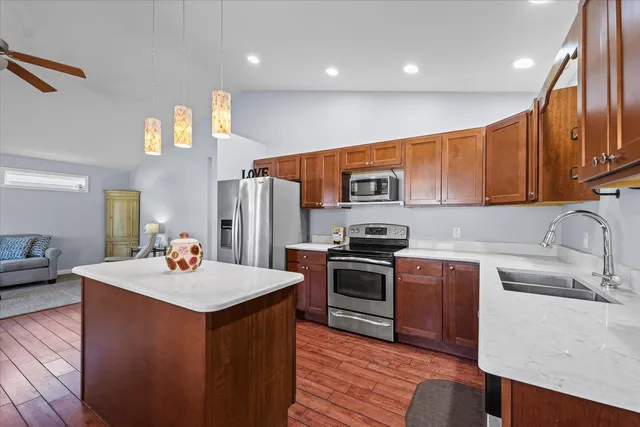 a kitchen with stainless steel appliances a sink stove and refrigerator