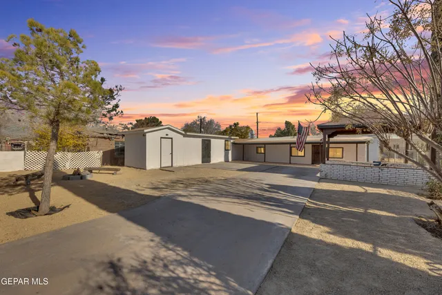 a front view of a house with a road