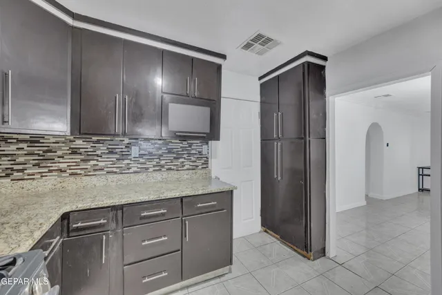 a kitchen with a refrigerator and cabinets
