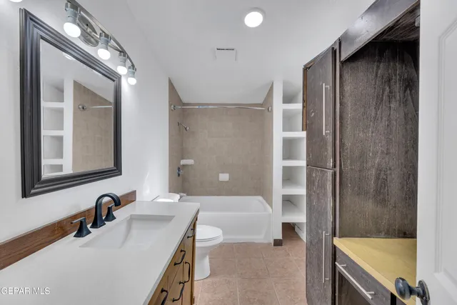 a bathroom with a tub sink and mirror