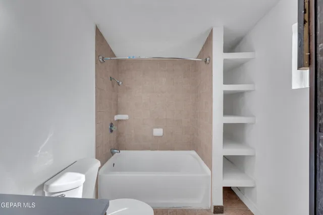 a bathroom with a bathtub and toilet