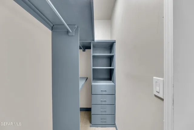 a view of walk in closet with empty racks