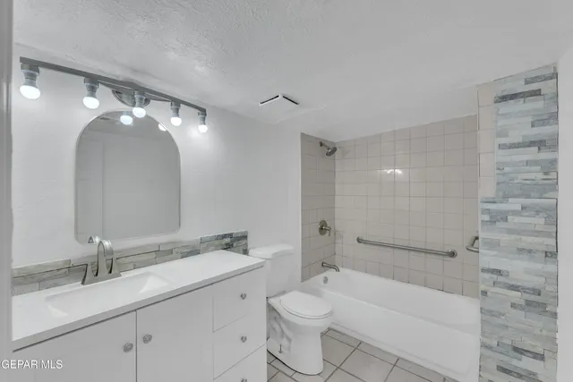 a bathroom with a double vanity sink toilet mirror and bathtub