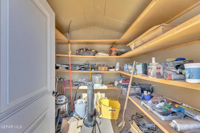 a room with stainless steel appliances lots of wooden furniture