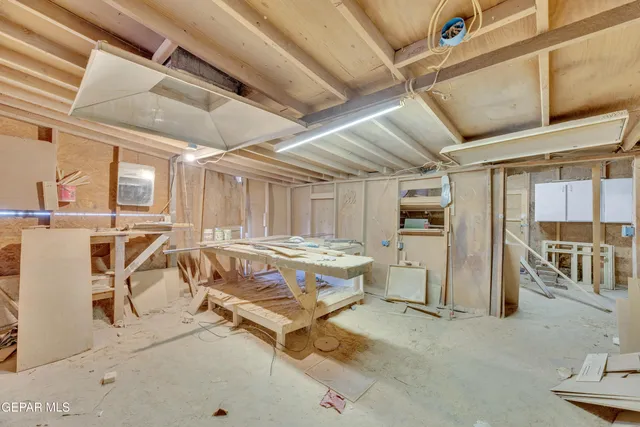 a room with table chairs and windows