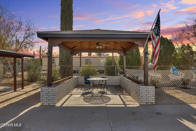 a view of a patio with a table and chairs