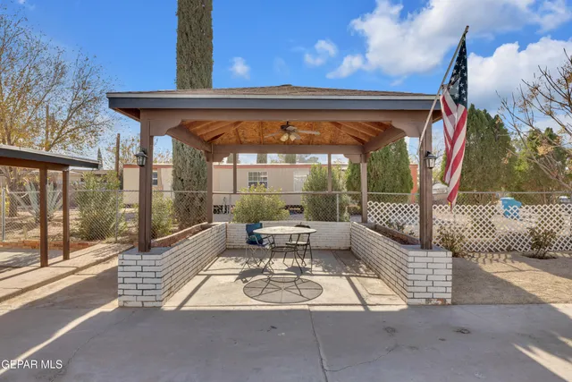 a building outdoor space with patio furniture and potted plants