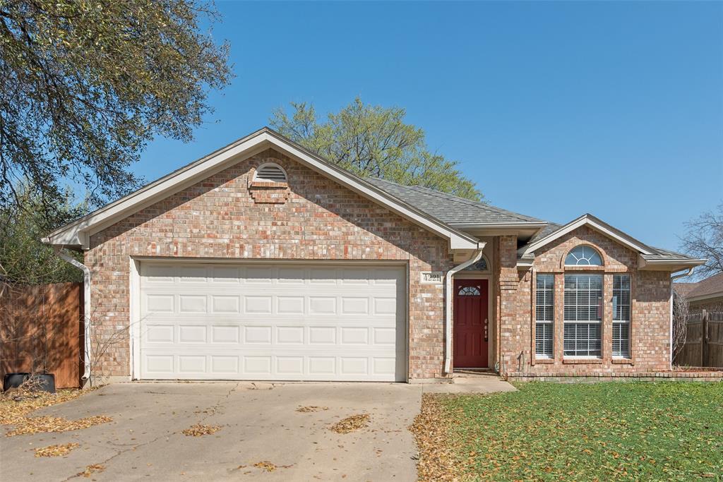 a front view of a house with a garden and plants