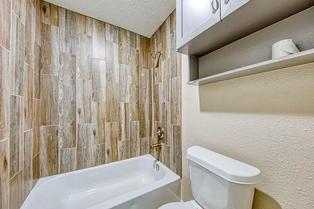 a bathroom with a toilet a sink and a shower