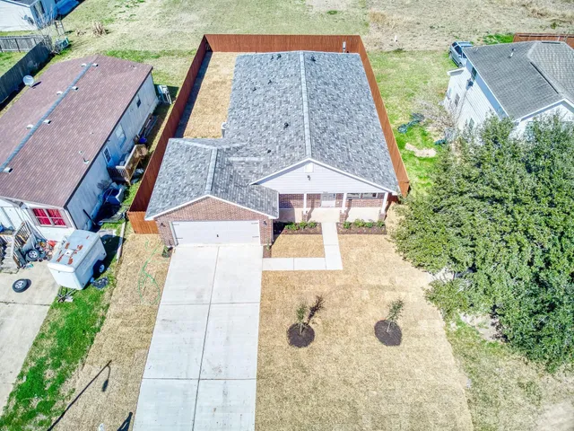 an aerial view of a house with yard