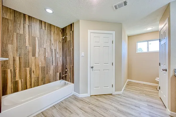 a view of a bathroom with a tub and shower