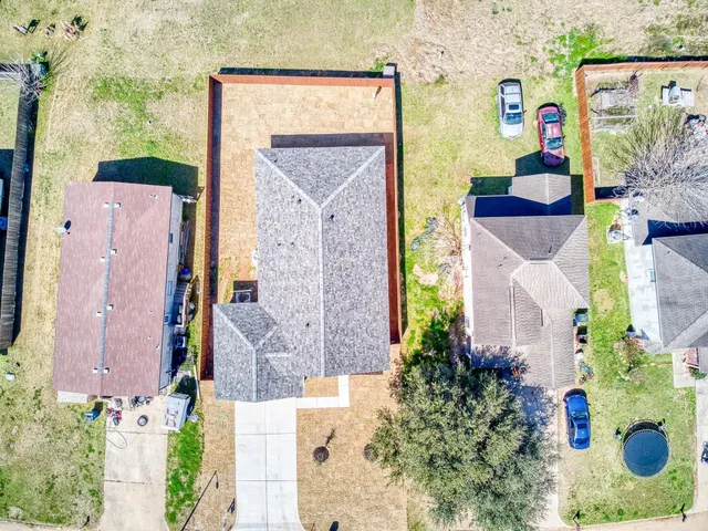 aerial view of a house with a yard