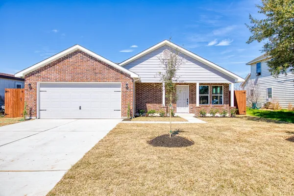a view of a house with a yard and sitting area